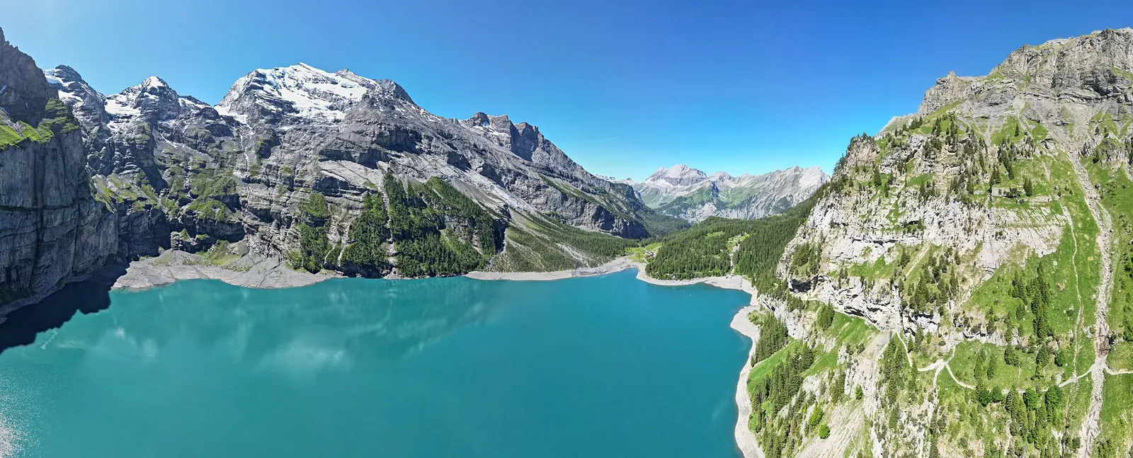 Turquoise Oeschinensee lake below the Blüemlisalp cliffs above Kandersteg