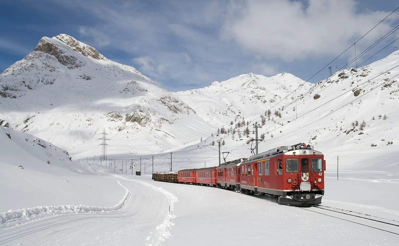 Bernina Express crossing a snowy landscape